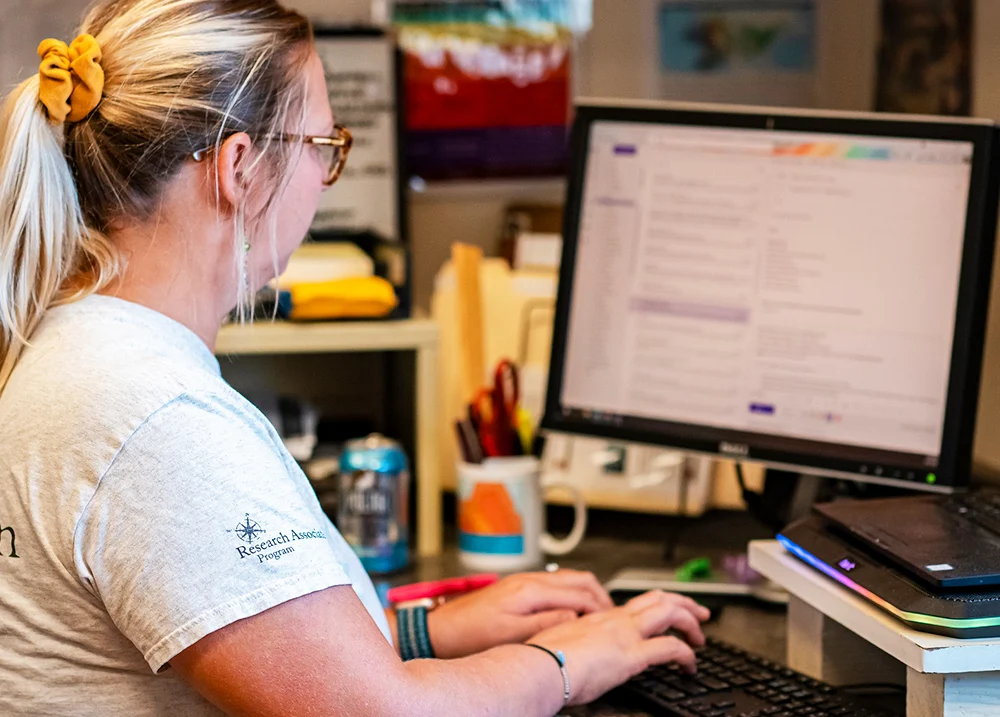Woman typing on a computer keyboard
