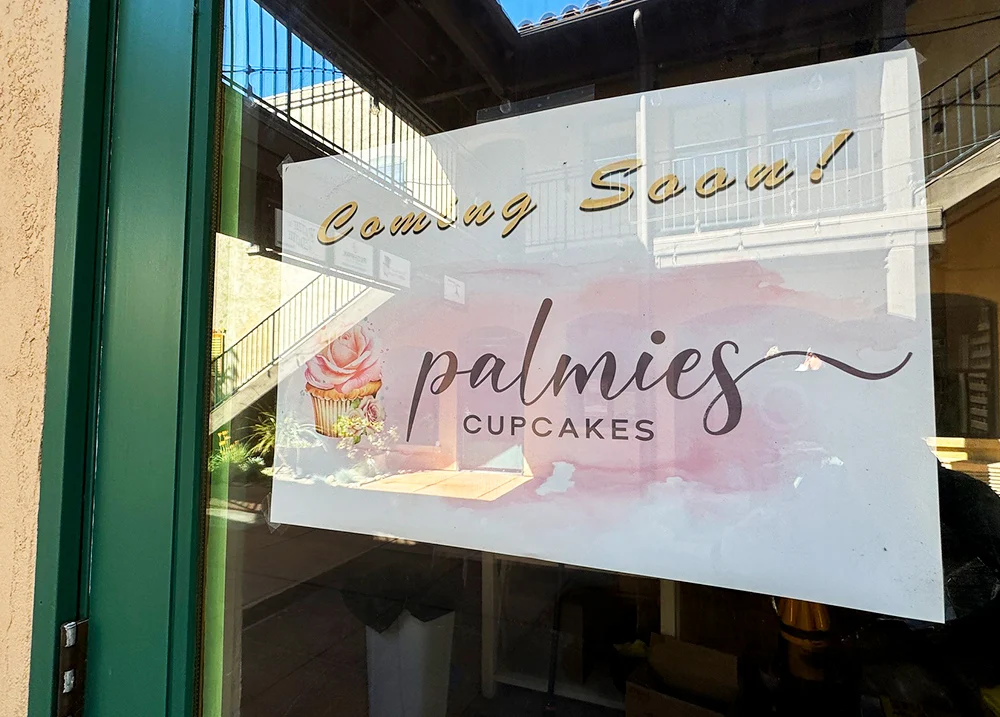 Door with a sign that says Coming Soon! Palmies Cupcakes
