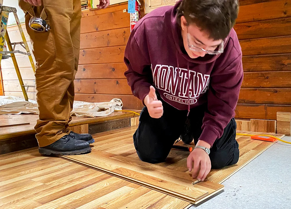 Person laying flooring