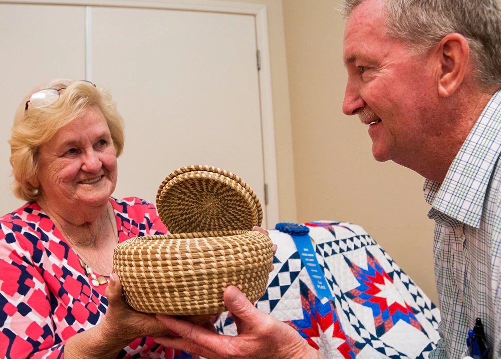 Man handing a woman a woven basket