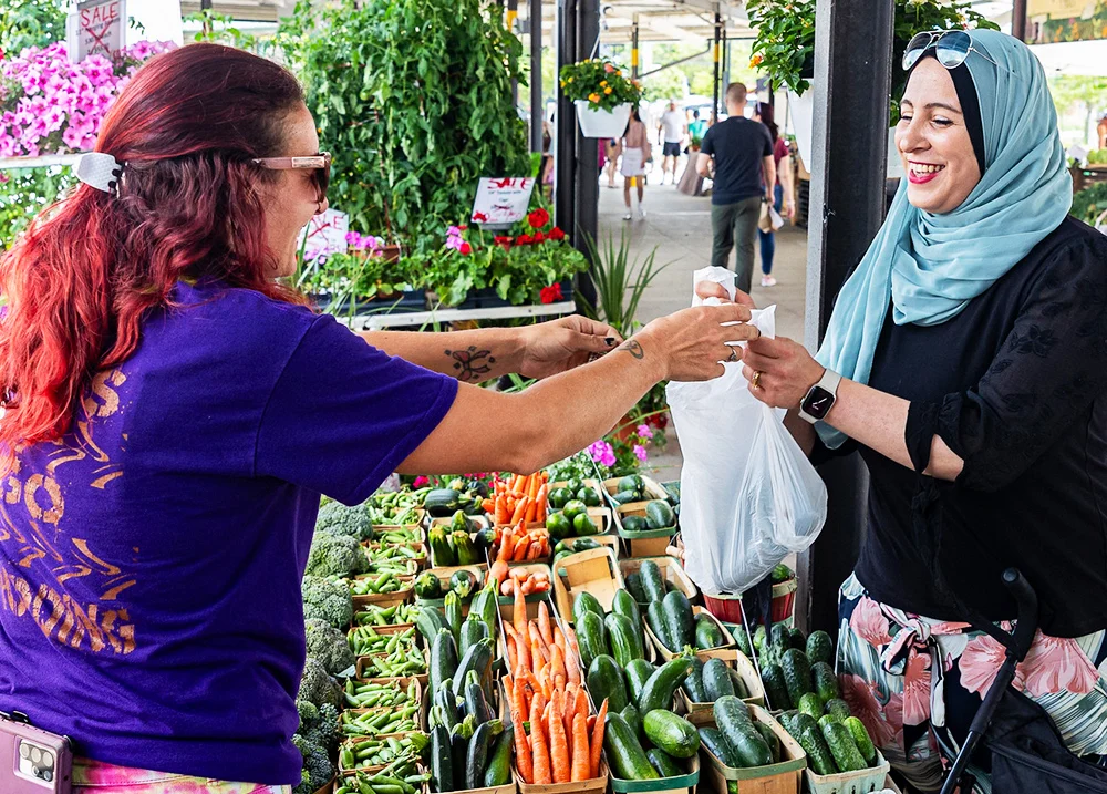Woman buying vegetables from a farmer's market