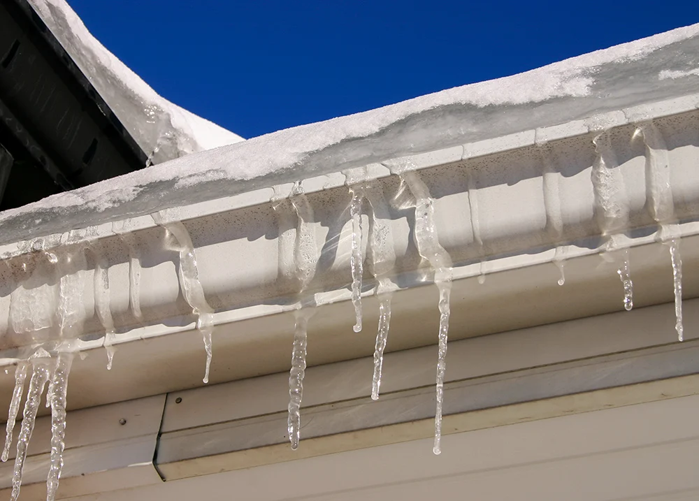 Icicles hanging over a frozen gutter