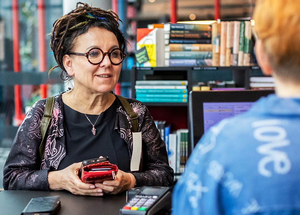Woman purchasing something at a bookstore