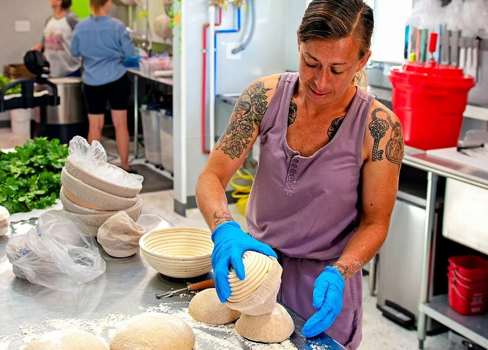 Woman making bread in a commercial kitchen