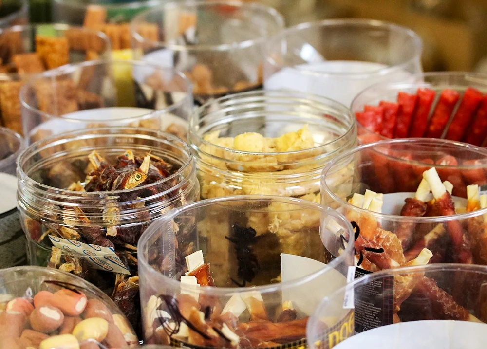 Dog treats for sale in plastic containers